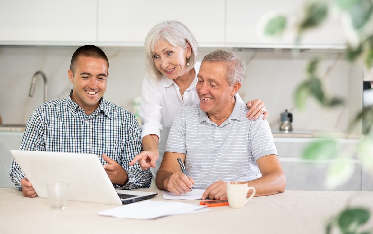 Couple reviewing homeowners insurance documents with an agent.